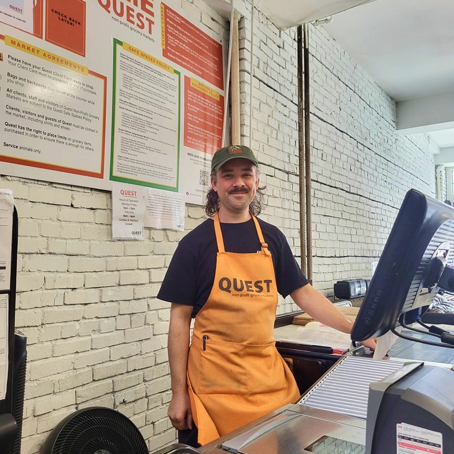 Person working at the Quest till