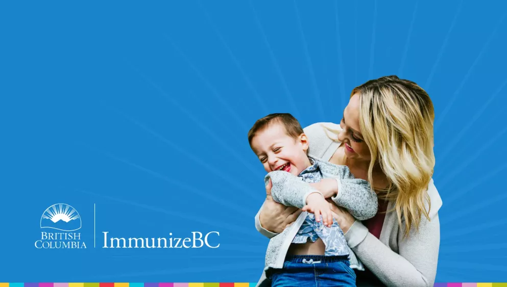 Woman holding and smiling at a laughing child. Immunize BC logo. 