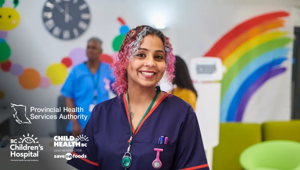 Photo of a health professional in scrubs, smiling at the camera