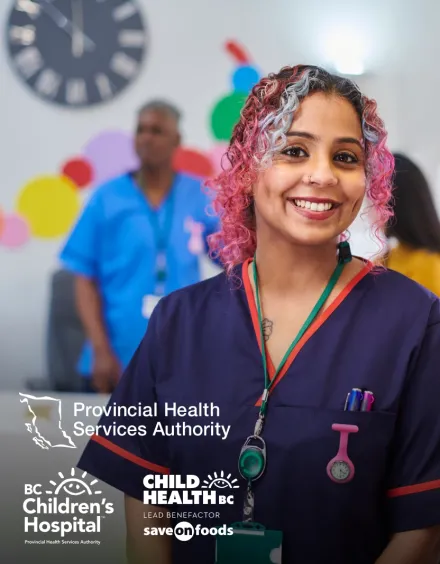 Photo of a health professional in scrubs, smiling at the camera